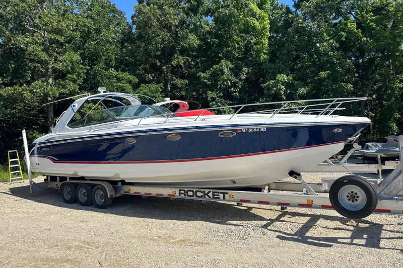 Slide: The Image of 2007 Formula 400 Super Sport boat on trailer, surrounded by trees. - 7