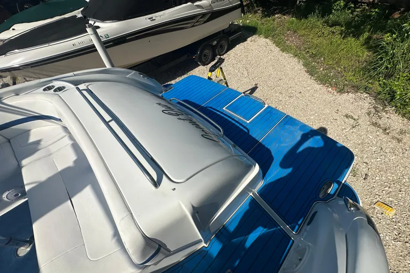 Slide: The Image of 2007 Formula 400 Super Sport boat with blue deck, parked on gravel. - 9
