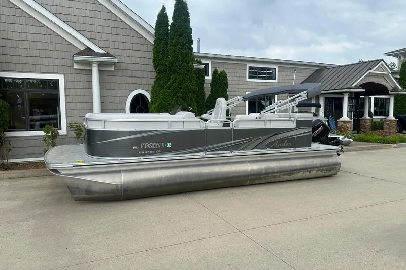 Slide: The Image of 2018 Avalon GS2185 pontoon boat parked outside a building. - 0