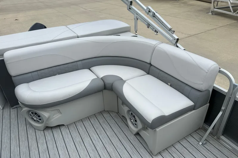 Slide: The Image of 2018 Avalon GS2185 boat seating with gray upholstery and integrated speakers on a wooden deck. - 12
