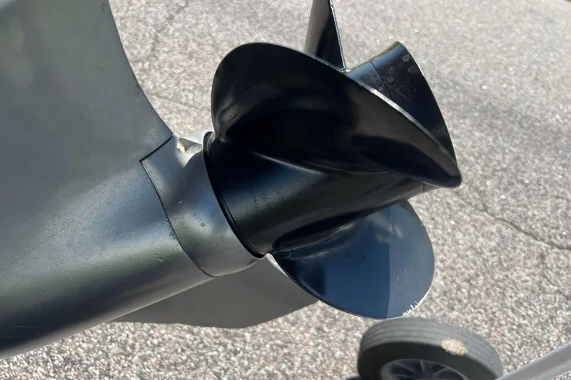 Slide: The Image of Close-up of a 2008 Four Winns H190 boat propeller on pavement. - 10
