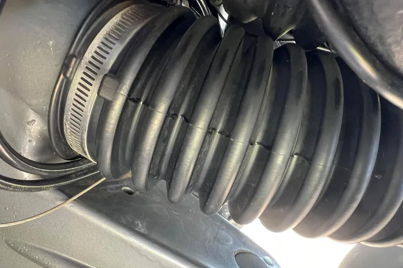 Slide: The Image of Close-up of a 2008 Four Winns H190 boat component, featuring a ribbed rubber hose. - 11