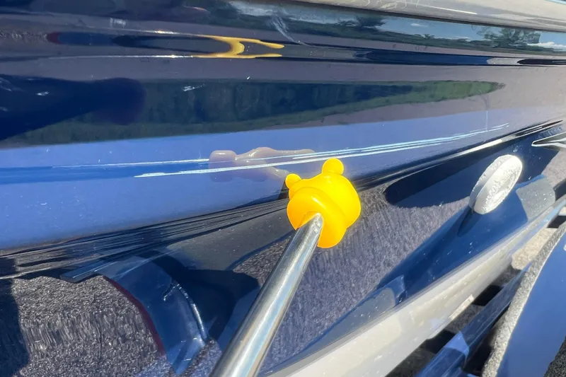 Slide: The Image of 2008 Four Winns H190 boat with a yellow suction cup tool attached. - 13