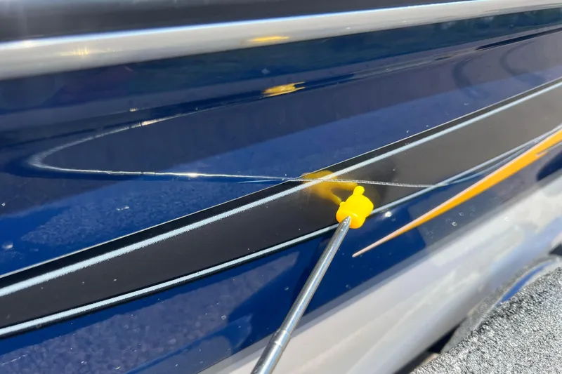 Slide: The Image of Close-up of a 2008 Four Winns H190 boat with a scratch and yellow marker. - 14