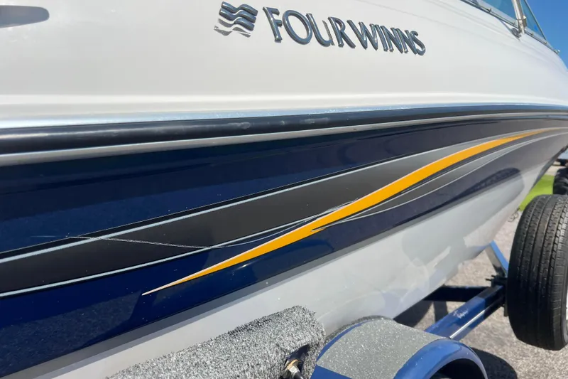 Slide: The Image of 2008 Four Winns H190 boat with sleek design and vibrant stripe detailing. - 15