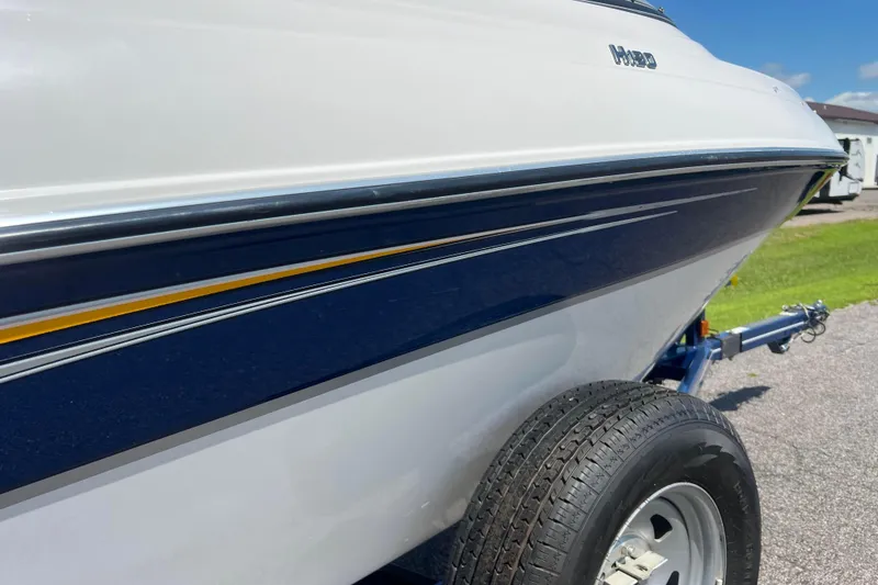 Slide: The Image of 2008 Four Winns H190 boat on trailer, featuring sleek blue and white design. - 18