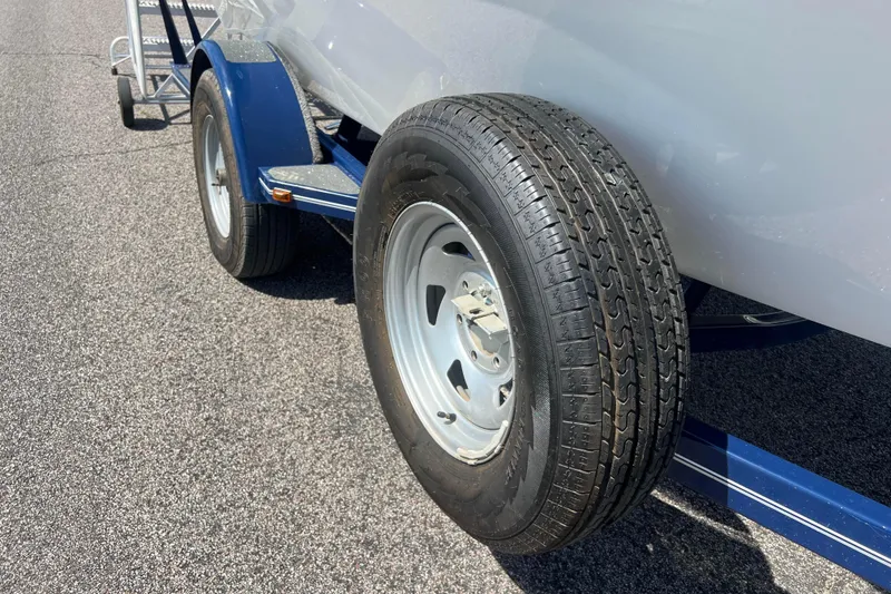 Slide: The Image of 2008 Four Winns H190 trailer tire on asphalt, showcasing wheel detail. - 19