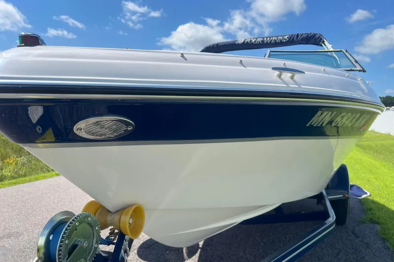 Slide: The Image of 2008 Four Winns H190 boat on trailer under blue sky. - 24