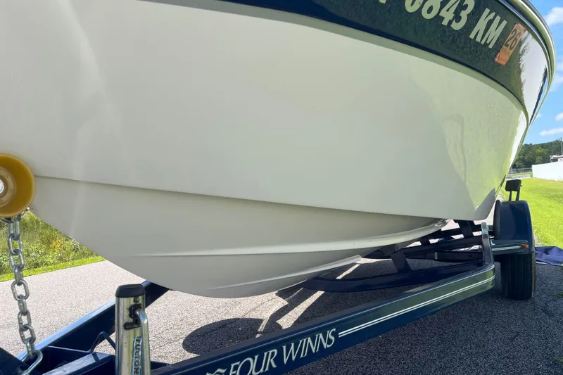 Slide: The Image of 2008 Four Winns H190 boat on trailer, close-up view of hull and trailer details. - 25