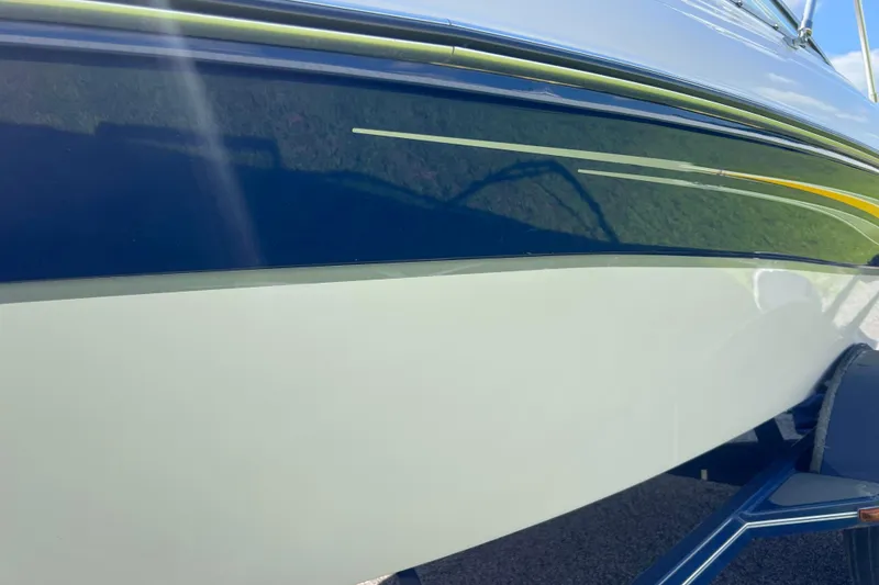 Slide: The Image of 2008 Four Winns H190 boat hull with blue and white design. - 27