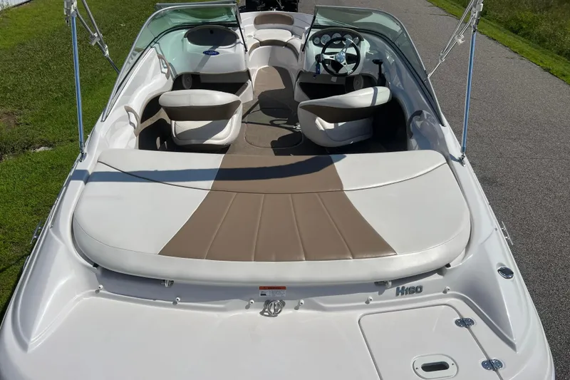 Slide: The Image of 2008 Four Winns H190 boat interior with white and beige seating, steering wheel, and windshield. - 3