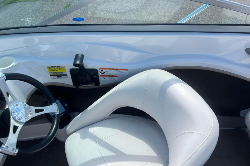 Slide: The Image of Interior of 2008 Four Winns H190 boat with steering wheel and white seat. - 38