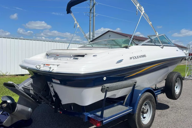Slide: The Image of 2008 Four Winns H190 boat on trailer under clear blue sky. - 4