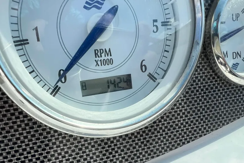 Slide: The Image of Close-up of 2008 Four Winns H190 RPM gauge displaying 142.4 hours. - 40
