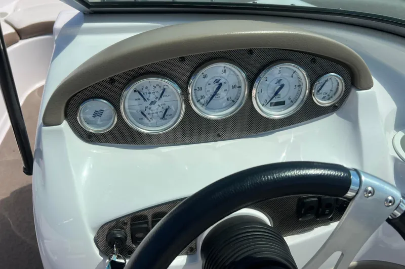 Slide: The Image of Dashboard of a 2008 Four Winns H190 boat with gauges and steering wheel. - 41