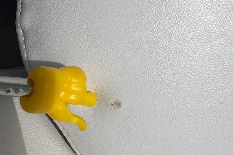 Slide: The Image of Yellow tool on white leather seat of 2008 Four Winns H190 boat. - 43