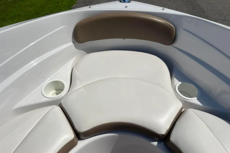 Slide: The Image of 2008 Four Winns H190 boat interior with white cushioned seating and cup holders. - 49