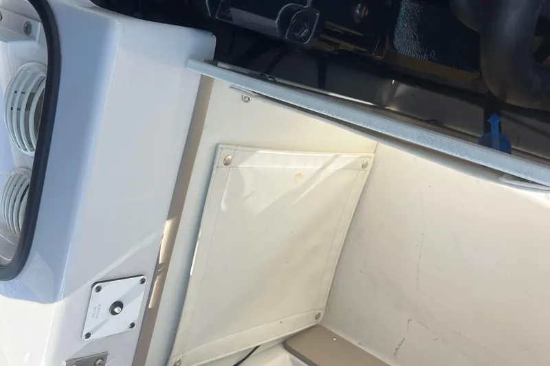 Slide: The Image of Interior view of a 2008 Four Winns H190 boat, showing storage compartment and ventilation. - 55