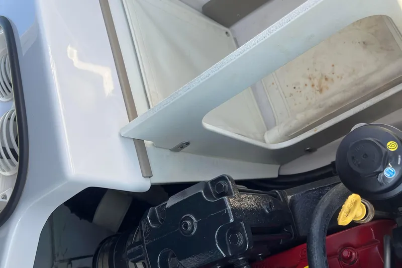 Slide: The Image of Engine compartment of a 2008 Four Winns H190 boat, showing mechanical components. - 56