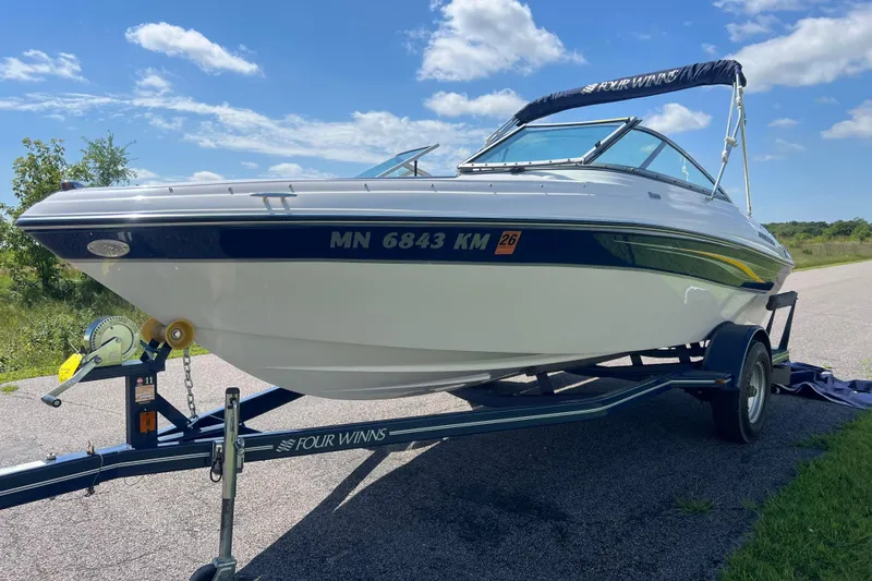 Slide: The Image of 2008 Four Winns H190 boat on trailer under blue sky. - 6