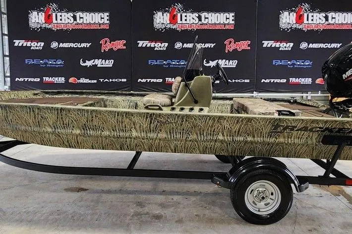 The Image of 2026 Tracker GRIZZLY® 1860 CC boat on trailer, camo design, displayed at Anglers Choice event. - 1