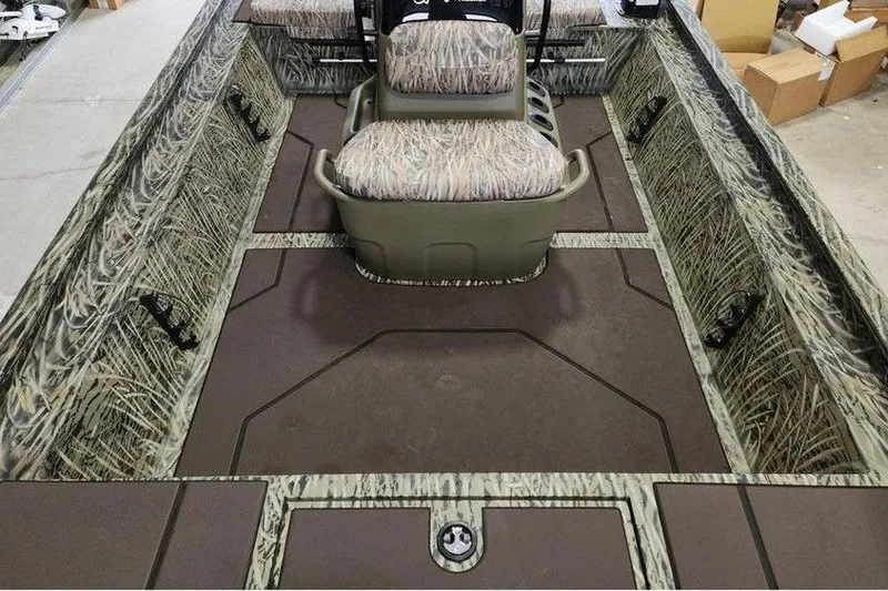 Slide: The Image of 2026 Tracker GRIZZLY® 1860 CC boat interior with camo seating and spacious layout. - 12