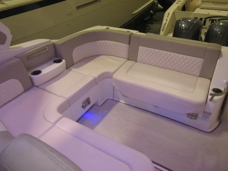 Slide: The Image of Luxurious seating area on a 2017 Chaparral 330 Signature boat, featuring white upholstery. - 11