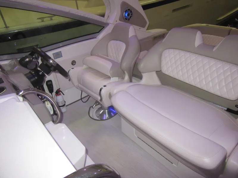 Slide: The Image of 2017 Chaparral 330 Signature boat interior with control panel and seating area. - 20