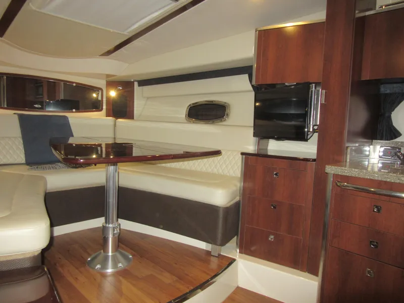 Slide: The Image of 2017 Chaparral 330 Signature interior with wood flooring and cushioned seating. - 23