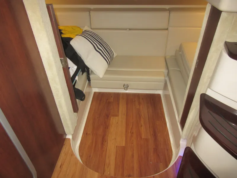 Slide: The Image of 2017 Chaparral 330 Signature interior with cream leather seating and ambient blue lighting. - 27