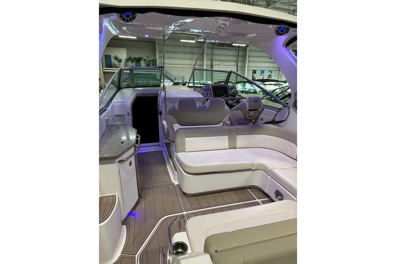 Slide: The Image of 2017 Chaparral 330 Signature interior with polished wood flooring and storage hatch. - 30