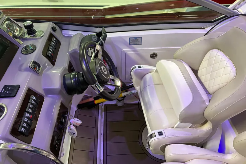 Slide: The Image of Helm of 2017 Chaparral 330 Signature boat with modern controls and steering wheel. - 34