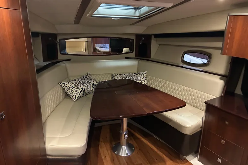 Slide: The Image of 2017 Chaparral 330 Signature boat deck with seating and shadow, docked at marina. - 39