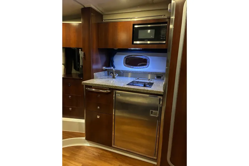 Slide: The Image of 2017 Chaparral 330 Signature boat in showroom, front view with sleek design. - 40