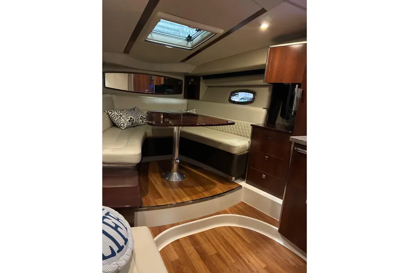 Slide: The Image of 2017 Chaparral 330 Signature cabin interior with elegant seating and wooden table. - 41