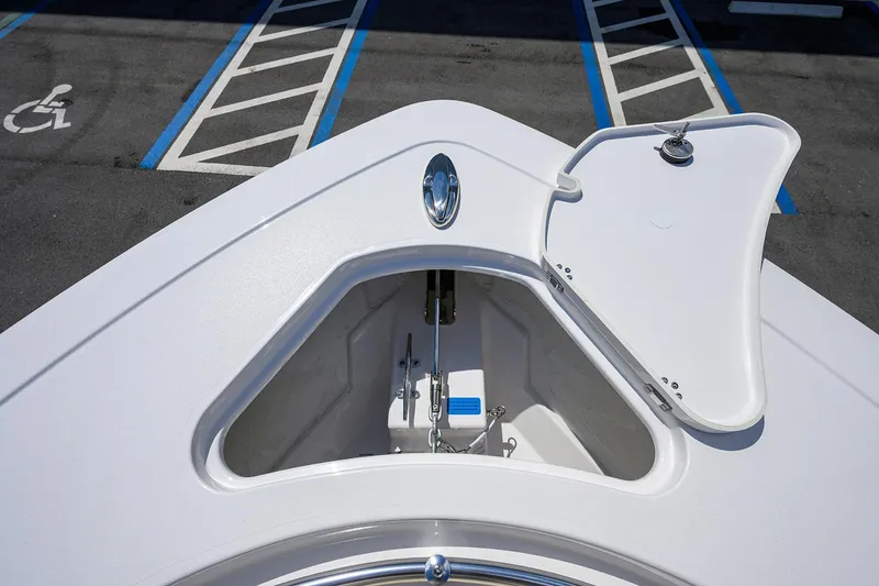 Slide: The Image of 2026 Sportsman Open 302 Center Console anchor compartment in a parking lot. - 11