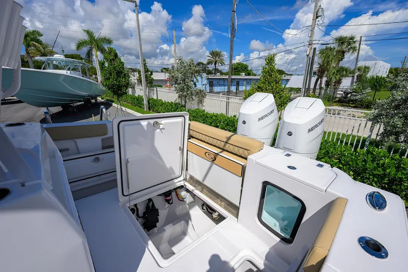 Slide: The Image of 2026 Sportsman Open 302 Center Console boat with Mercury engines and open storage compartment. - 19