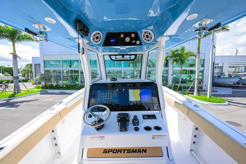 Slide: The Image of 2026 Sportsman Open 302 Center Console boat interior with modern dashboard and steering wheel. - 26