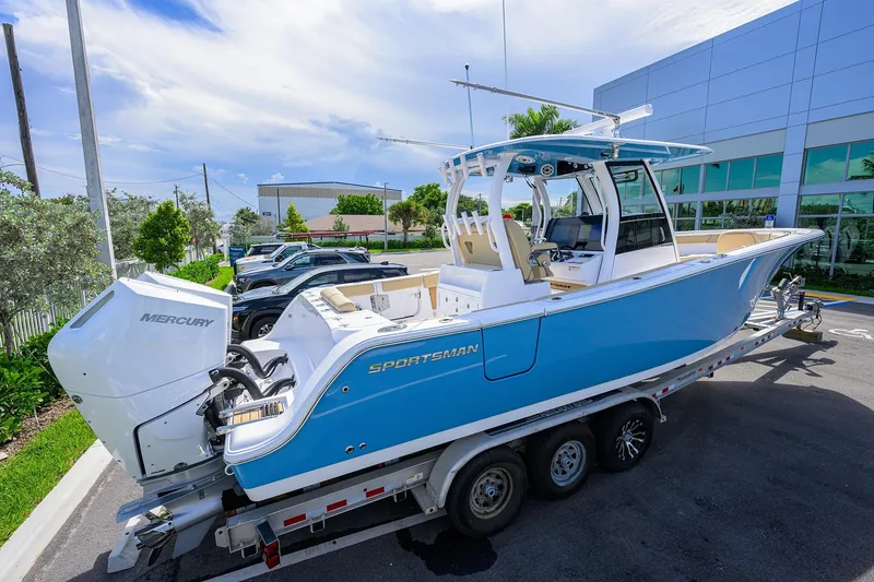 Slide: The Image of 2026 Sportsman Open 302 Center Console boat on trailer, featuring Mercury engine. - 3