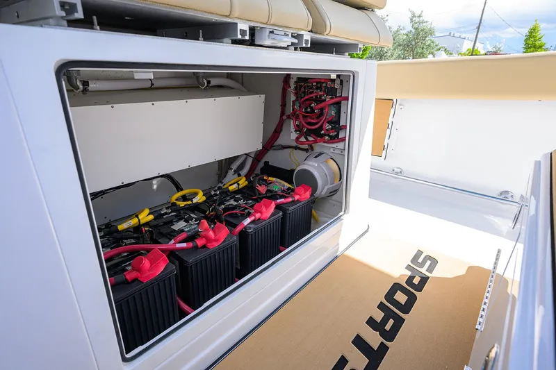Slide: The Image of 2026 Sportsman Open 302 Center Console battery compartment with wiring and equipment. - 31