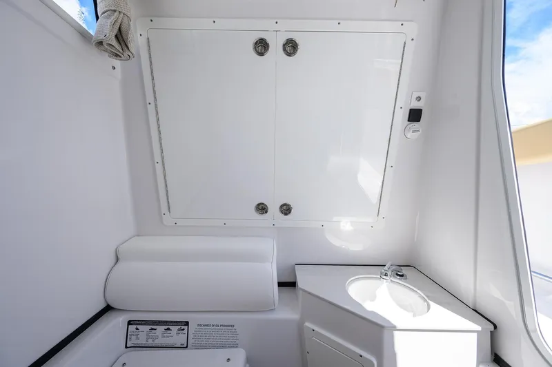 Slide: The Image of 2026 Sportsman Open 302 Center Console interior with storage and sink. - 34