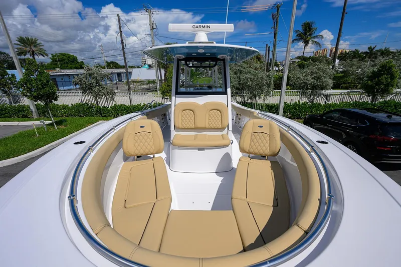 Slide: The Image of 2026 Sportsman Open 302 Center Console boat with tan seating and Garmin equipment. - 4