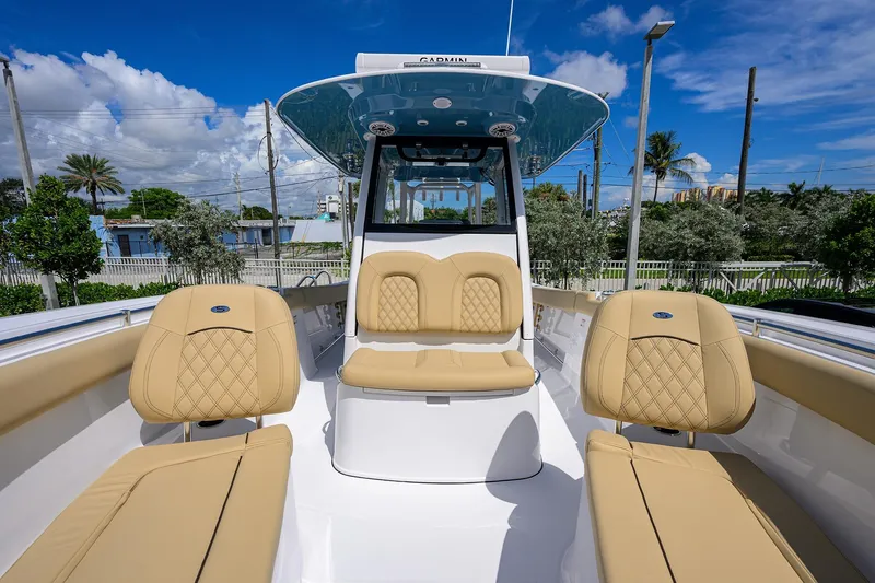 Slide: The Image of 2026 Sportsman Open 302 Center Console boat with tan seating and sleek design. - 5