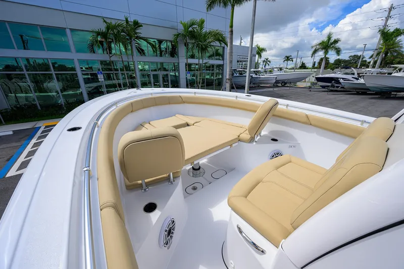 Slide: The Image of 2026 Sportsman Open 302 Center Console boat with beige seating, docked near palm trees. - 8