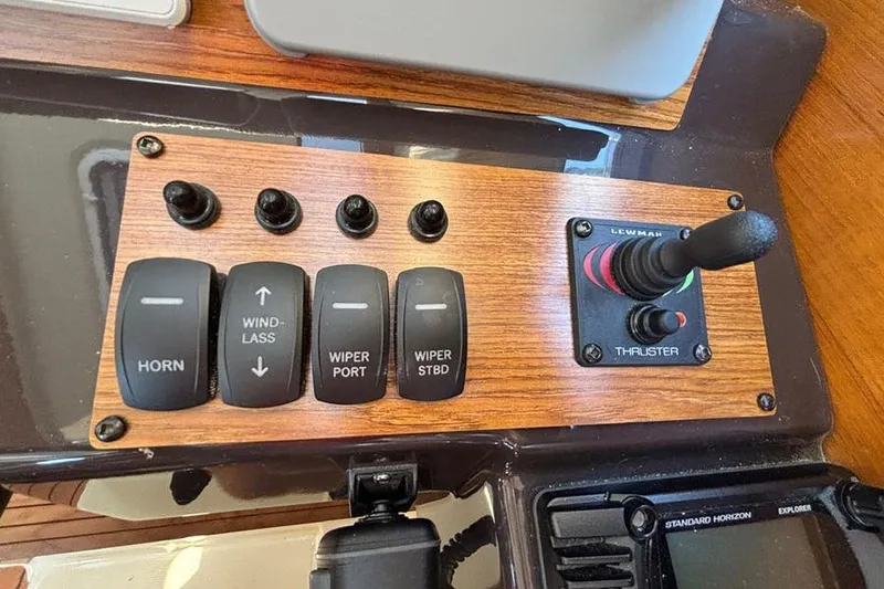 Slide: The Image of Control panel of a 2021 Ranger Tugs R-27 boat with switches and thruster joystick. - 16