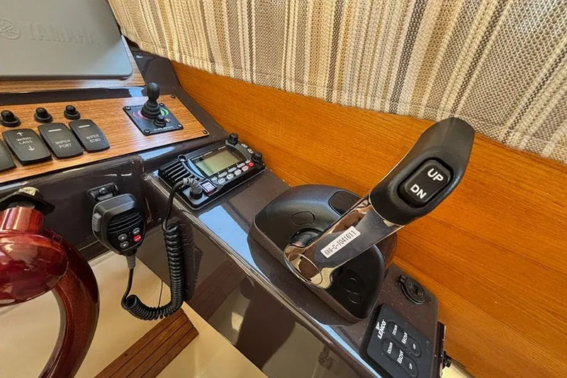 Slide: The Image of Control panel of 2021 Ranger Tugs R-27 boat with joystick and radio equipment. - 17