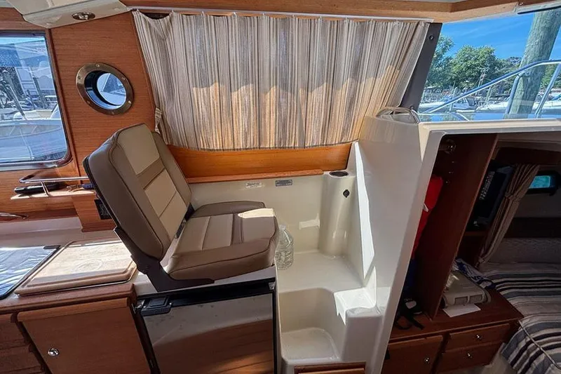 Slide: The Image of Interior of 2021 Ranger Tugs R-27 boat with seating and window view. - 18