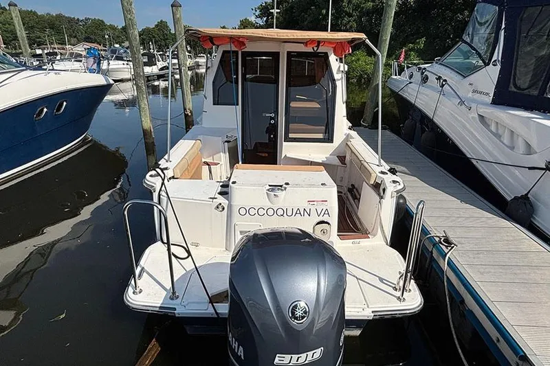 Slide: The Image of 2021 Ranger Tugs R-27 boat docked, rear view with Yamaha engine, Occoquan VA. - 2