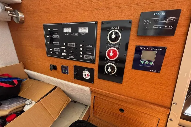 Slide: The Image of Control panel of a 2021 Ranger Tugs R-27 boat with various switches and gauges. - 21