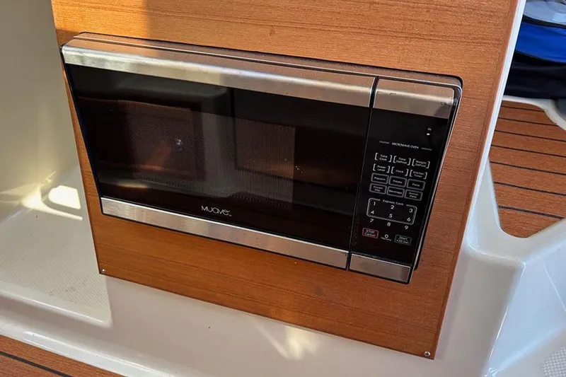 Slide: The Image of Microwave oven in 2021 Ranger Tugs R-27 boat interior, wood paneling. - 29